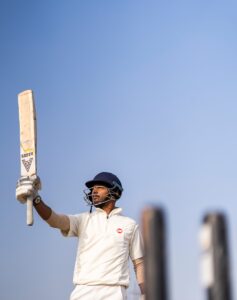 a man holding a cricket bat in his hand